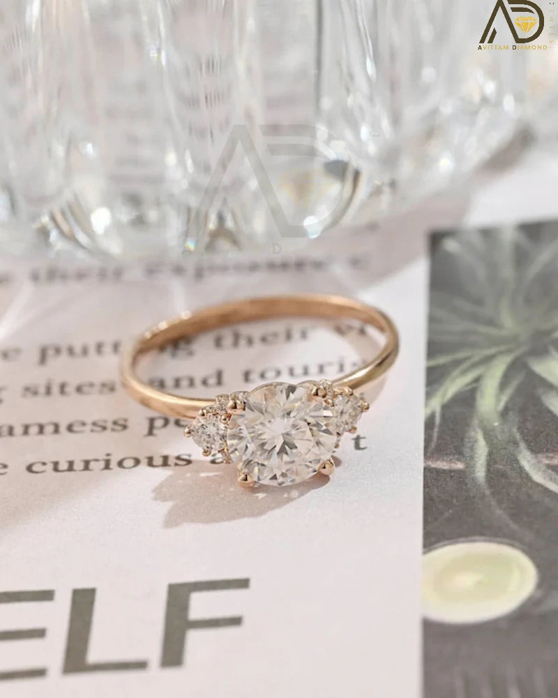 Discover our Three Stone Round Cut Moissanite Ring, a stunning choice for her engagement. Its elegant design and brilliance make it an unforgettable symbol of love.
