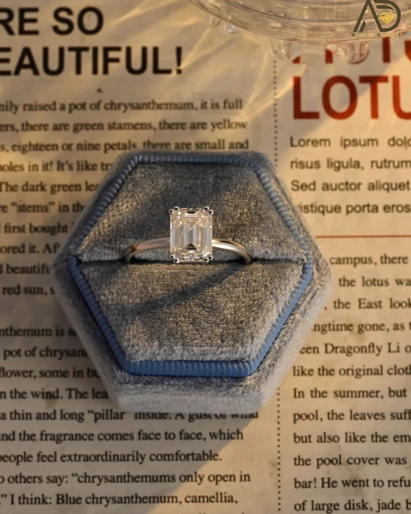 This stunning colorless Moissanite ring showcases a timeless emerald cut design, making it an ideal choice for any bride. Handcrafted and affordable luxury.