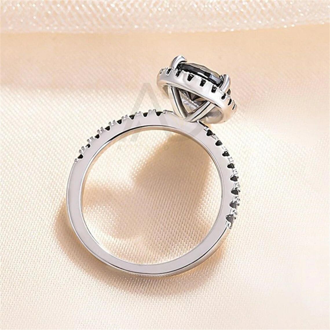 pear diamond ring, pear moissanite ring, halo bridal ring, pear wedding ring, halo promise ring, vintage pear ring, elegant pear ring, unique pear ring, classic pear ring, custom pear ring, gold pear ring, platinum pear ring, silver pear ring, pear eternity ring, pear three stone ring, halo anniversary ring, luxury pear ring, dainty pear ring, simple pear ring