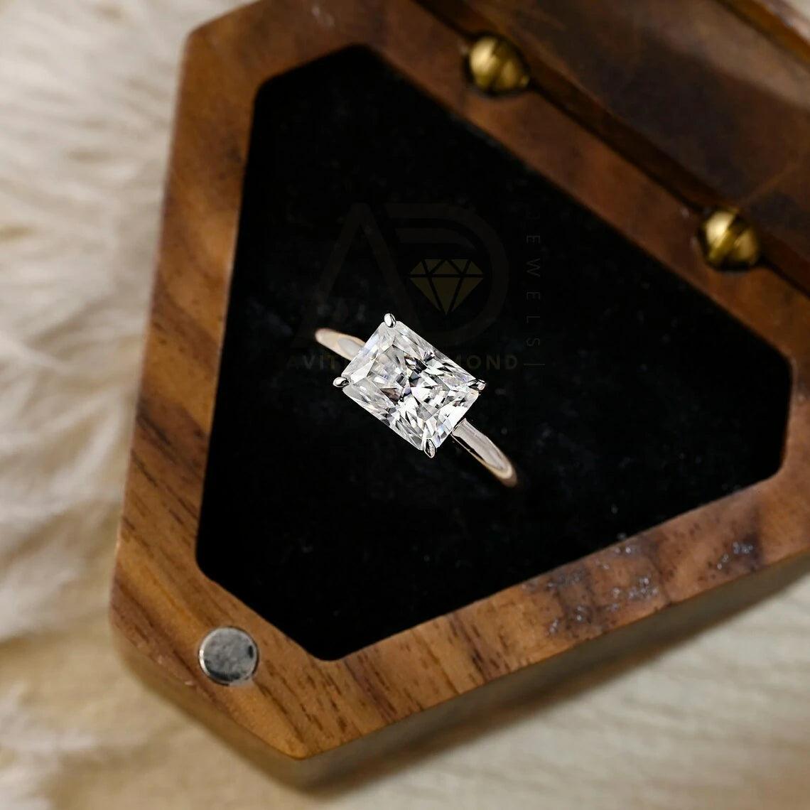 Discover elegance with our West to East Radiant Cut Solitaire Moissanite Engagement Ring. Crafted with a 3.00-carat radiant-cut moissanite diamond, Perfect for weddings or anniversaries. Shop now!