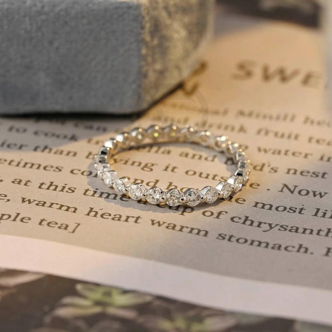 Certainly! Here are more SEO tags for your title: Round moissanite band, Solid gold wedding band, Moissanite eternity band, Bridal jewelry, Anniversary ring, Eternity wedding band, Gold bridal band, Matching moissanite band, Customizable wedding band, Sparkling bridal jewelry