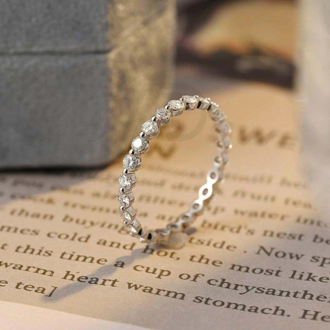 Certainly! Here are more SEO tags for your title: Round moissanite band, Solid gold wedding band, Moissanite eternity band, Bridal jewelry, Anniversary ring, Eternity wedding band, Gold bridal band, Matching moissanite band, Customizable wedding band, Sparkling bridal jewelry