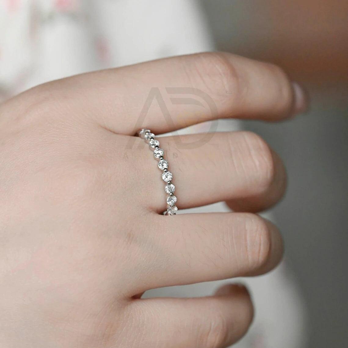 Certainly! Here are more SEO tags for your title: Round moissanite band, Solid gold wedding band, Moissanite eternity band, Bridal jewelry, Anniversary ring, Eternity wedding band, Gold bridal band, Matching moissanite band, Customizable wedding band, Sparkling bridal jewelry