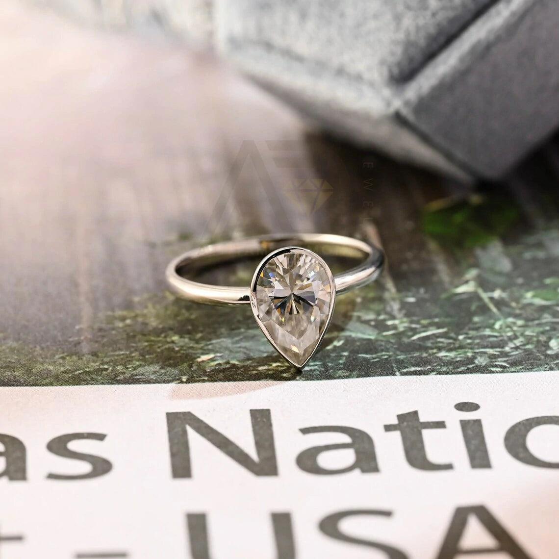 halo pear ring, pear engagement ring, pear halo ring, halo diamond ring, halo moissanite ring, pear cut ring, pear diamond ring, pear moissanite ring, halo bridal ring, pear wedding ring, halo promise ring, vintage pear ring, elegant pear ring, unique pear ring, classic pear ring, custom pear ring, gold pear ring, platinum pear ring, silver pear ring, pear eternity ring,