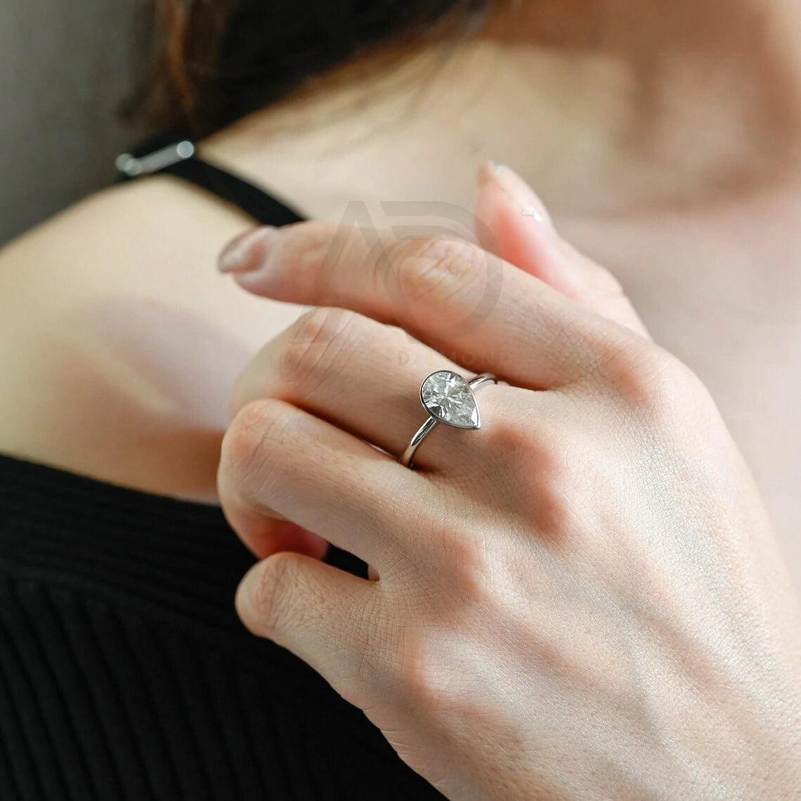 halo pear ring, pear engagement ring, pear halo ring, halo diamond ring, halo moissanite ring, pear cut ring, pear diamond ring, pear moissanite ring, halo bridal ring, pear wedding ring, halo promise ring, vintage pear ring, elegant pear ring, unique pear ring, classic pear ring, custom pear ring, gold pear ring, platinum pear ring, silver pear ring, pear eternity ring,