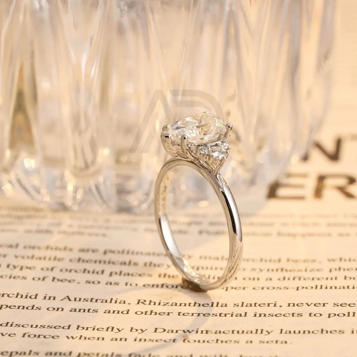 Pear Moissanite Engagement Ring, Teardrop Shaped Moissanite Ring, Round Accent Stone Ring, Solid Gold Promise Ring, Anniversary Gift for Women, Customizable Fine Jewelry, Unique Wedding Band, Luxurious Symbol of Love, Timeless Elegance, Romantic Anniversary Jewelry