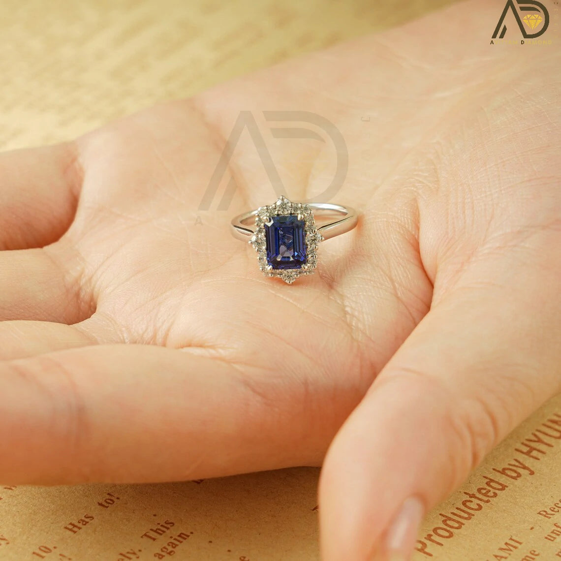 This luxurious handmade engagement ring features a vibrant emerald cut lab-grown sapphire in solid 10K, 14K, or 18K gold. Its unique cluster design is perfect for engagements, anniversaries, or special occasions.