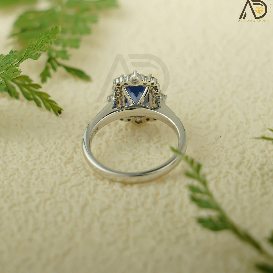 This luxurious handmade engagement ring features a vibrant emerald cut lab-grown sapphire in solid 10K, 14K, or 18K gold. Its unique cluster design is perfect for engagements, anniversaries, or special occasions.