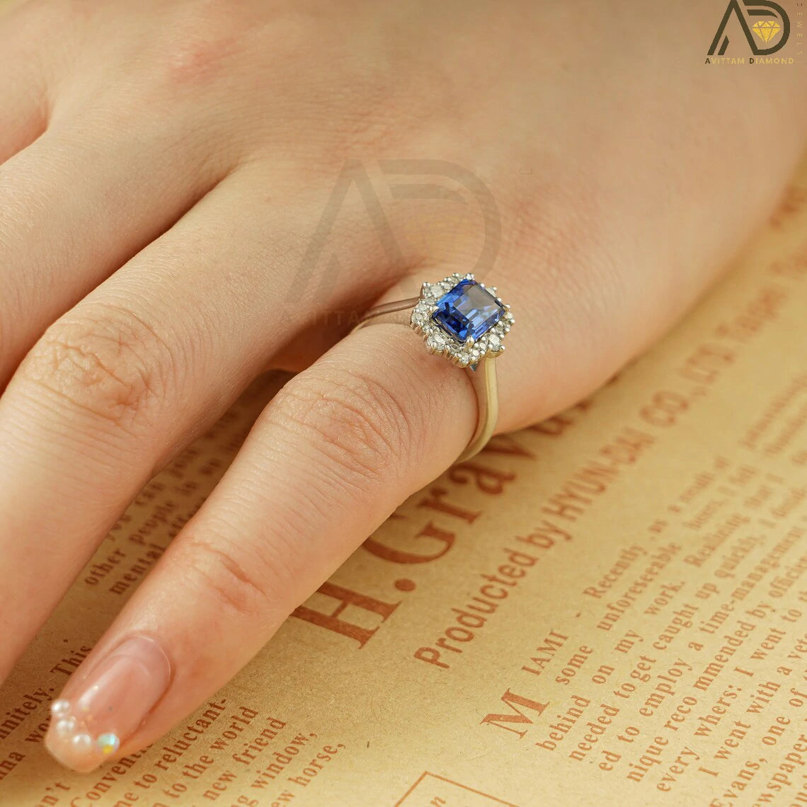 This luxurious handmade engagement ring features a vibrant emerald cut lab-grown sapphire in solid 10K, 14K, or 18K gold. Its unique cluster design is perfect for engagements, anniversaries, or special occasions.