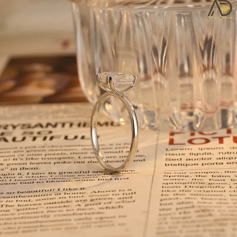 This stunning colorless Moissanite ring showcases a timeless emerald cut design, making it an ideal choice for any bride. Handcrafted and affordable luxury.