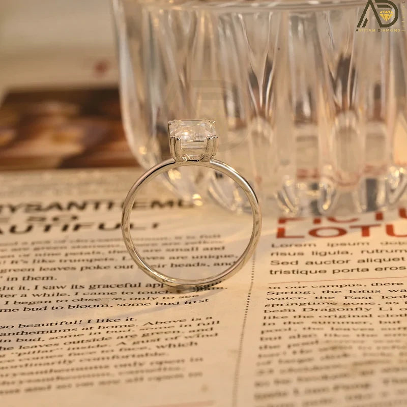 This stunning colorless Moissanite ring showcases a timeless emerald cut design, making it an ideal choice for any bride. Handcrafted and affordable luxury.