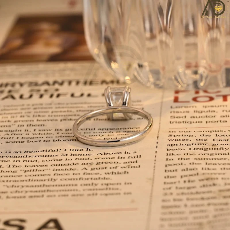 This stunning colorless Moissanite ring showcases a timeless emerald cut design, making it an ideal choice for any bride. Handcrafted and affordable luxury.