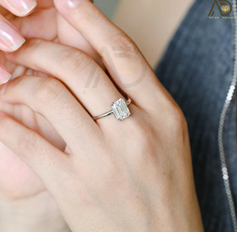 This stunning colorless Moissanite ring showcases a timeless emerald cut design, making it an ideal choice for any bride. Handcrafted and affordable luxury.
