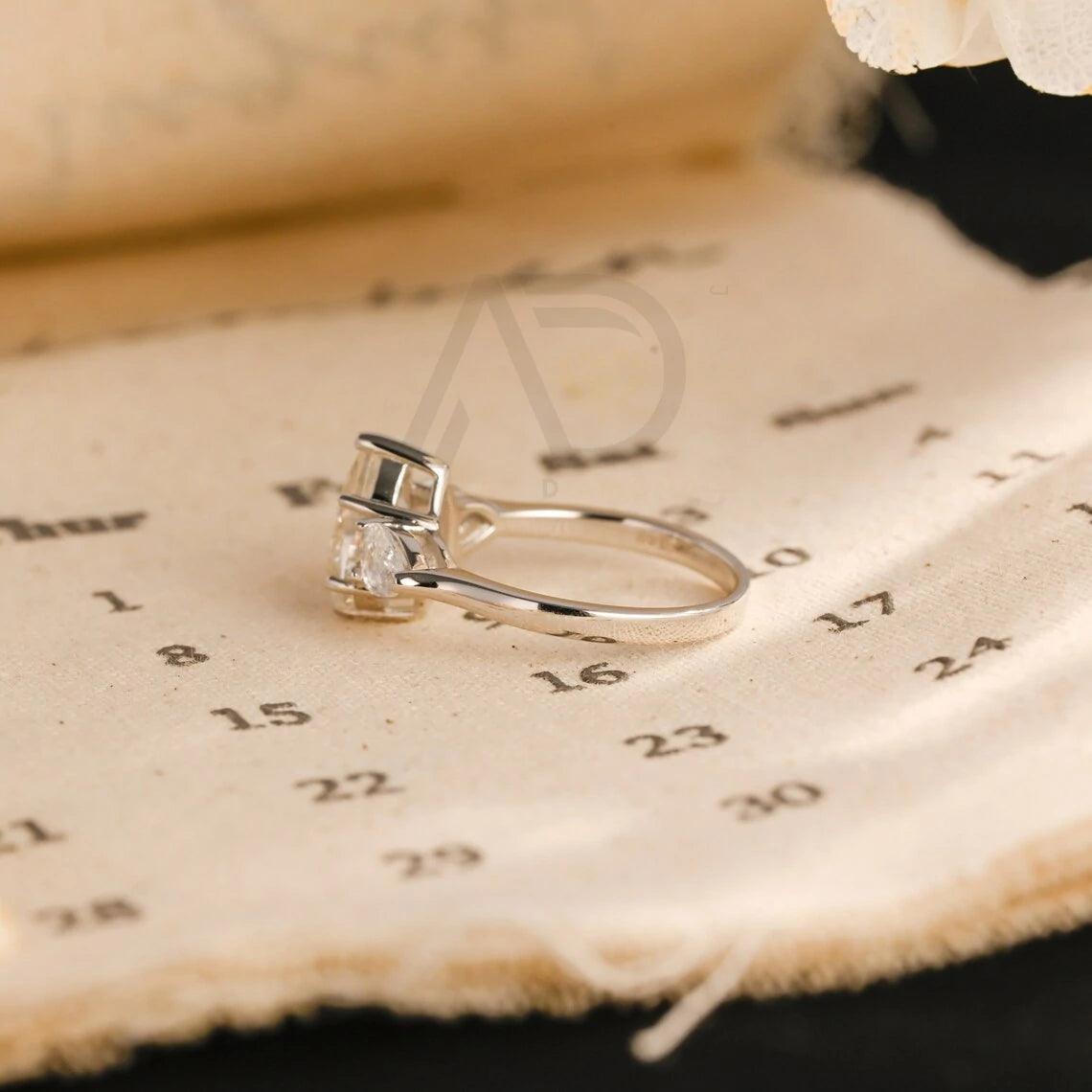 Pear Cut Three Stone Moissanite Engagement Ring. Perfect for weddings, promises, or anniversaries. Shop Now!