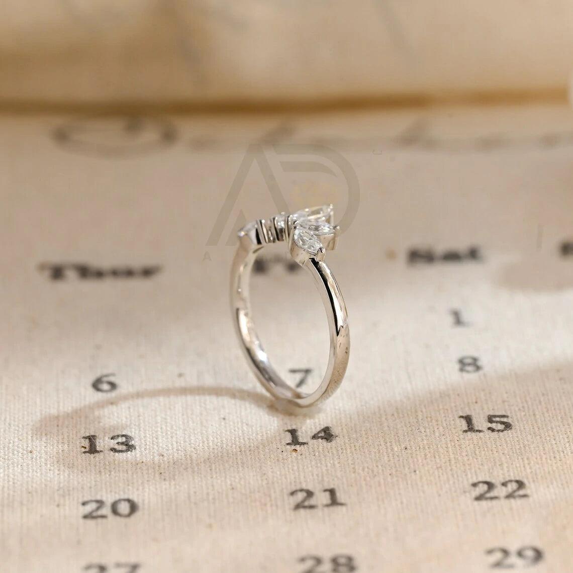 marquise wedding band, moissanite ring, wedding jewelry, bridal band, diamond alternative, anniversary gift, gold band, silver band, platinum band, handcrafted ring, dainty jewelry, elegant design, timeless beauty, luxury ring, custom made, fine jewelry, sparkling gemstone, modern elegance, statement piece, designer band, unique design, high-quality craftsmanship, affordable luxury