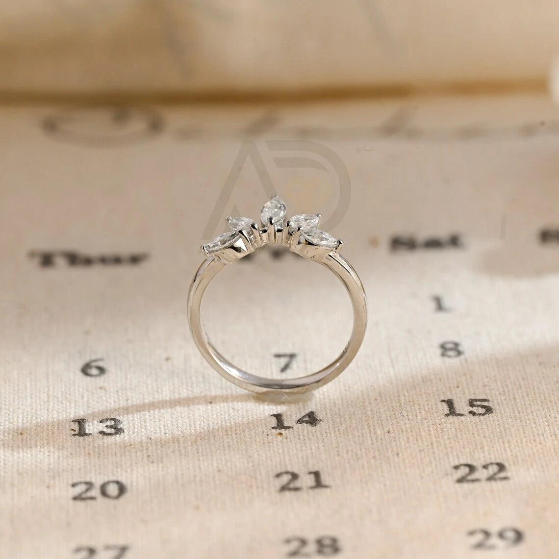 marquise wedding band, moissanite ring, wedding jewelry, bridal band, diamond alternative, anniversary gift, gold band, silver band, platinum band, handcrafted ring, dainty jewelry, elegant design, timeless beauty, luxury ring, custom made, fine jewelry, sparkling gemstone, modern elegance, statement piece, designer band, unique design, high-quality craftsmanship, affordable luxury