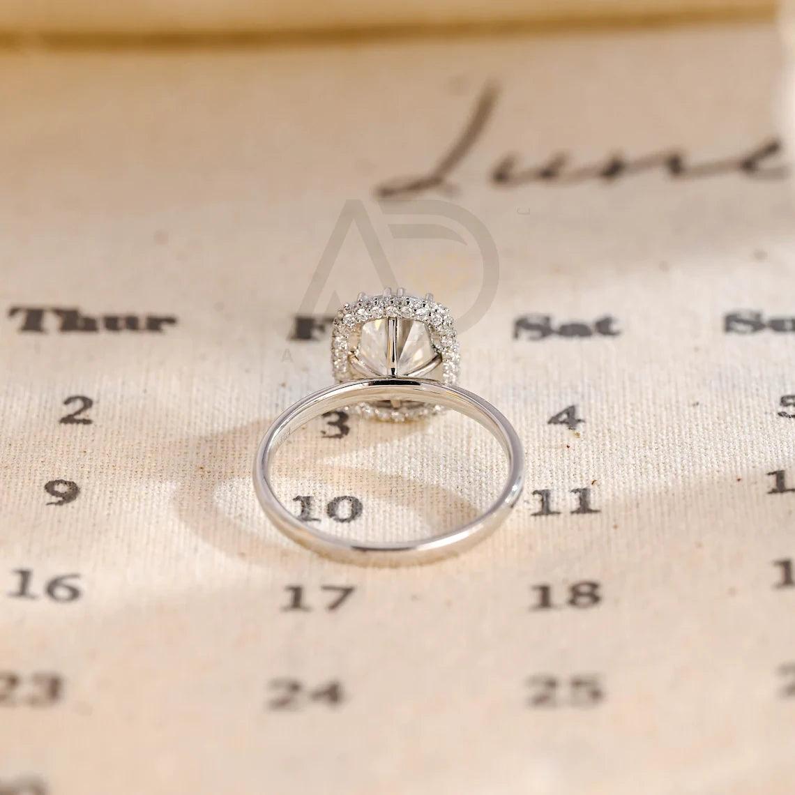 Halo Vintage Moissanite Engagement Ring. Crafted with precision, this ring features a 3Ct Moissanite Diamond in a Cushion Cut. Enjoy complimentary engraving and swift production. Shop now!