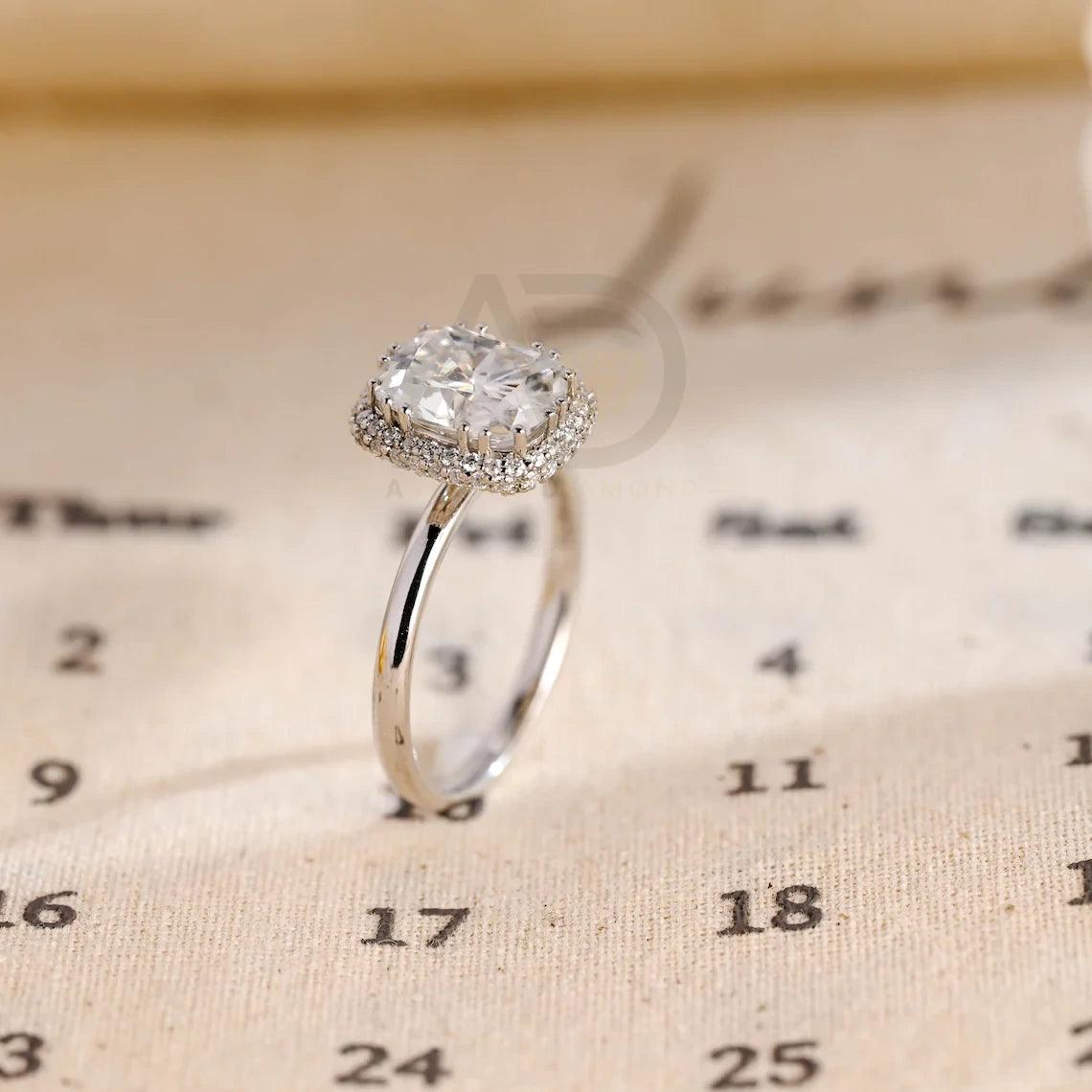 Halo Vintage Moissanite Engagement Ring. Crafted with precision, this ring features a 3Ct Moissanite Diamond in a Cushion Cut. Enjoy complimentary engraving and swift production. Shop now!