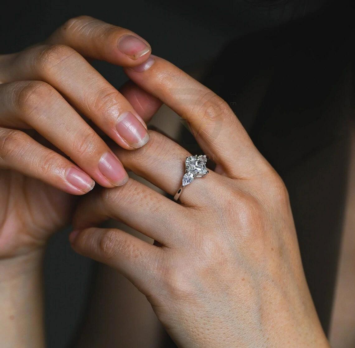 Pear Cut Three Stone Moissanite Engagement Ring. Perfect for weddings, promises, or anniversaries. Shop Now!