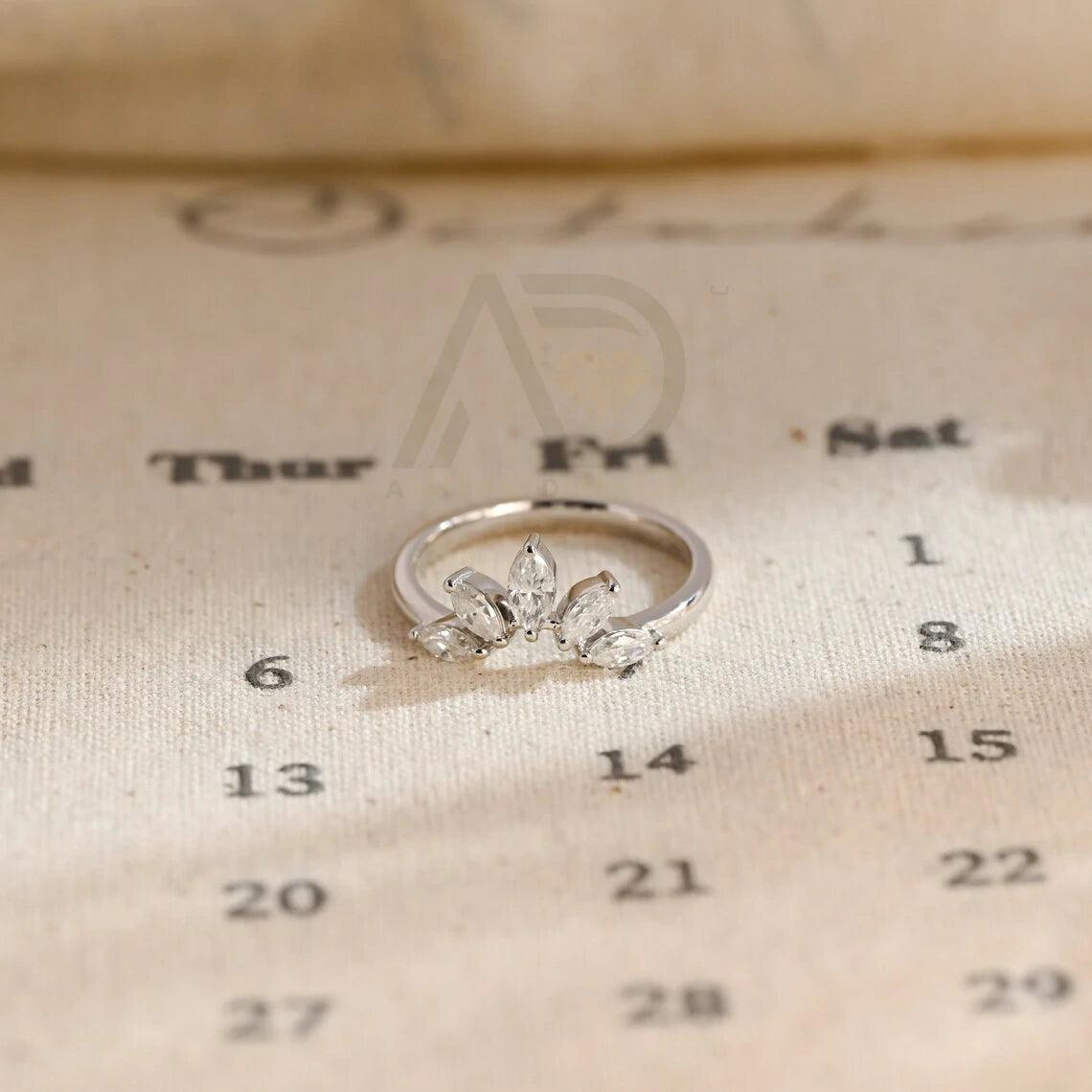 marquise wedding band, moissanite ring, wedding jewelry, bridal band, diamond alternative, anniversary gift, gold band, silver band, platinum band, handcrafted ring, dainty jewelry, elegant design, timeless beauty, luxury ring, custom made, fine jewelry, sparkling gemstone, modern elegance, statement piece, designer band, unique design, high-quality craftsmanship, affordable luxury