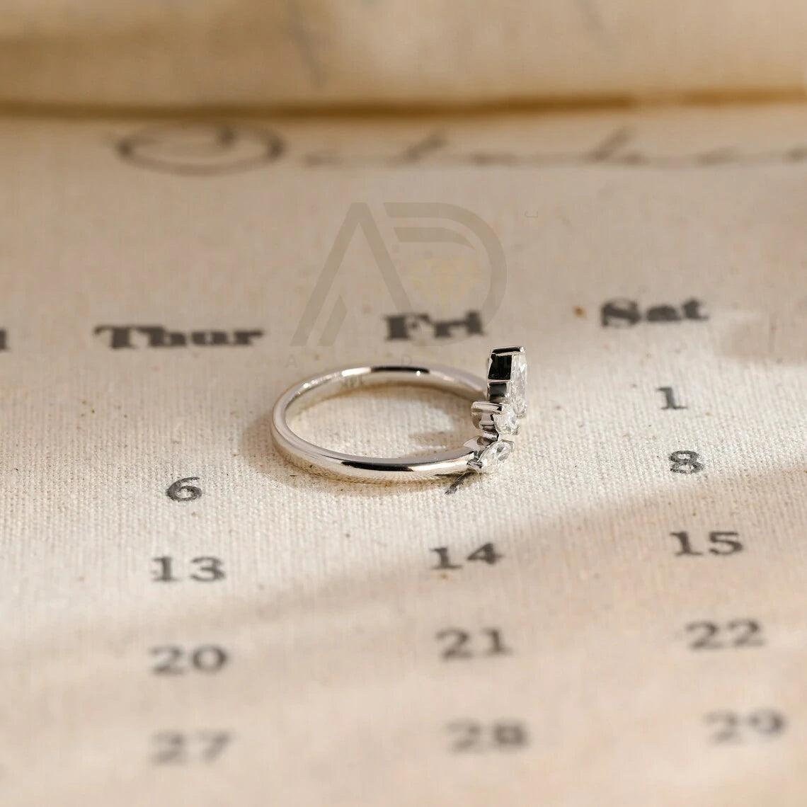 marquise wedding band, moissanite ring, wedding jewelry, bridal band, diamond alternative, anniversary gift, gold band, silver band, platinum band, handcrafted ring, dainty jewelry, elegant design, timeless beauty, luxury ring, custom made, fine jewelry, sparkling gemstone, modern elegance, statement piece, designer band, unique design, high-quality craftsmanship, affordable luxury