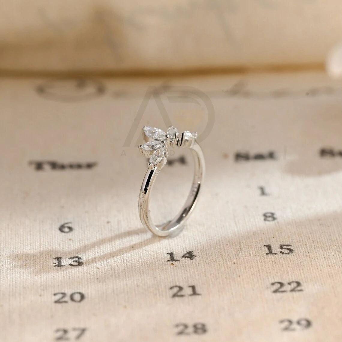 marquise wedding band, moissanite ring, wedding jewelry, bridal band, diamond alternative, anniversary gift, gold band, silver band, platinum band, handcrafted ring, dainty jewelry, elegant design, timeless beauty, luxury ring, custom made, fine jewelry, sparkling gemstone, modern elegance, statement piece, designer band, unique design, high-quality craftsmanship, affordable luxury