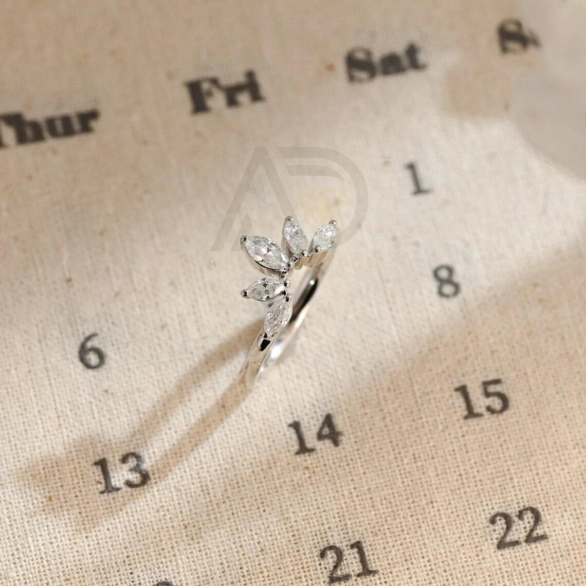 marquise wedding band, moissanite ring, wedding jewelry, bridal band, diamond alternative, anniversary gift, gold band, silver band, platinum band, handcrafted ring, dainty jewelry, elegant design, timeless beauty, luxury ring, custom made, fine jewelry, sparkling gemstone, modern elegance, statement piece, designer band, unique design, high-quality craftsmanship, affordable luxury