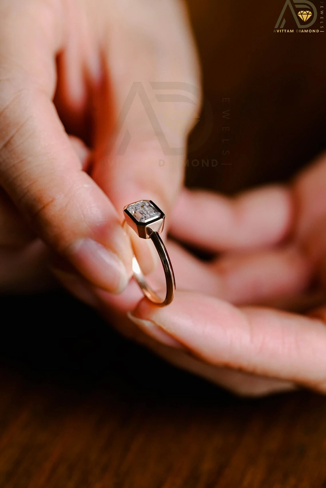 Celebrate your love with this solid gold East to West emerald cut moissanite engagement ring. Ideal for proposals, promises, anniversaries, or Christmas gifts. A stunning, timeless design for her.