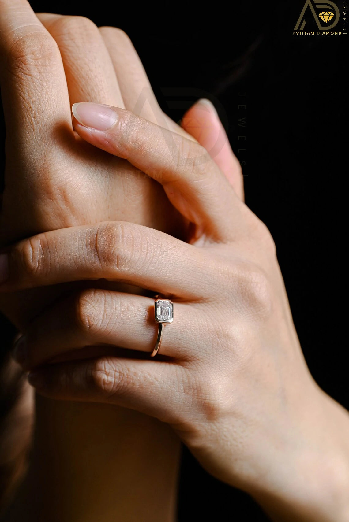 Celebrate your love with this solid gold East to West emerald cut moissanite engagement ring. Ideal for proposals, promises, anniversaries, or Christmas gifts. A stunning, timeless design for her.