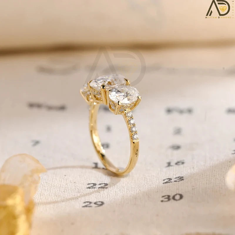 Discover our Three Stone Oval Cut Moissanite Engagement Ring, featuring a classic and unique design. Perfect for expressing your love with timeless elegance!