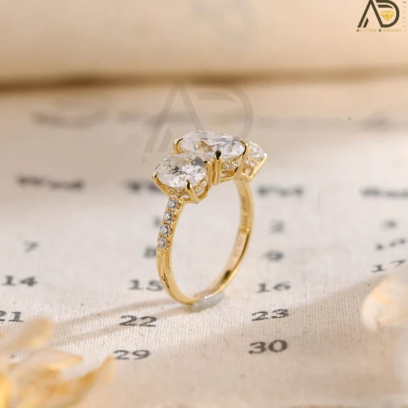 Discover our Three Stone Oval Cut Moissanite Engagement Ring, featuring a classic and unique design. Perfect for expressing your love with timeless elegance!