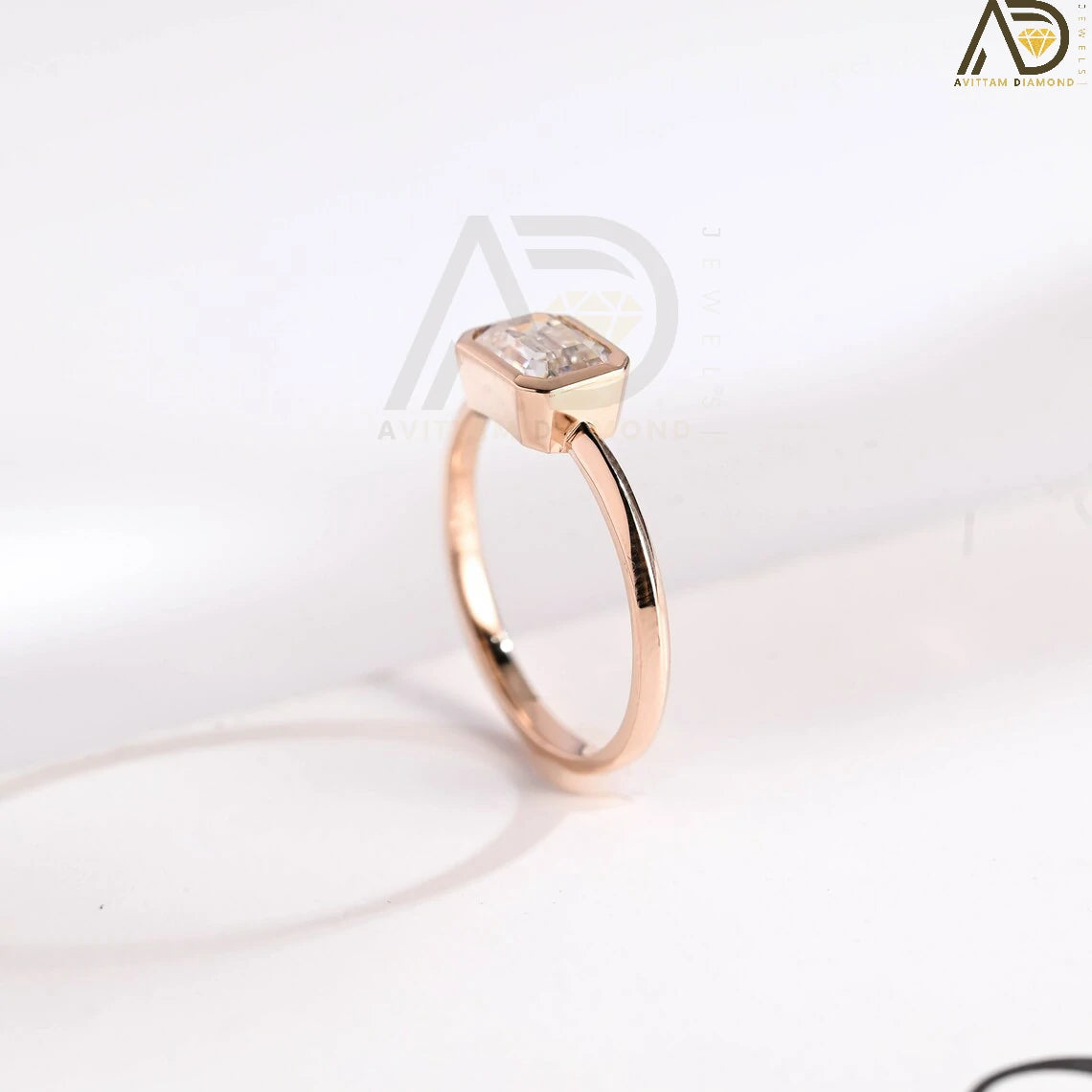 Celebrate your love with this solid gold East to West emerald cut moissanite engagement ring. Ideal for proposals, promises, anniversaries, or Christmas gifts. A stunning, timeless design for her.