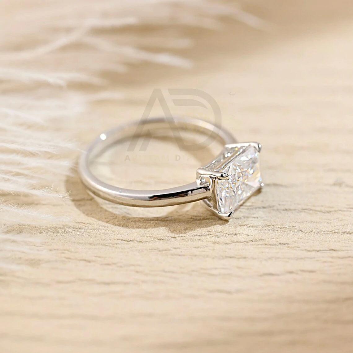 Discover elegance with our West to East Radiant Cut Solitaire Moissanite Engagement Ring. Crafted with a 3.00-carat radiant-cut moissanite diamond, Perfect for weddings or anniversaries. Shop now!