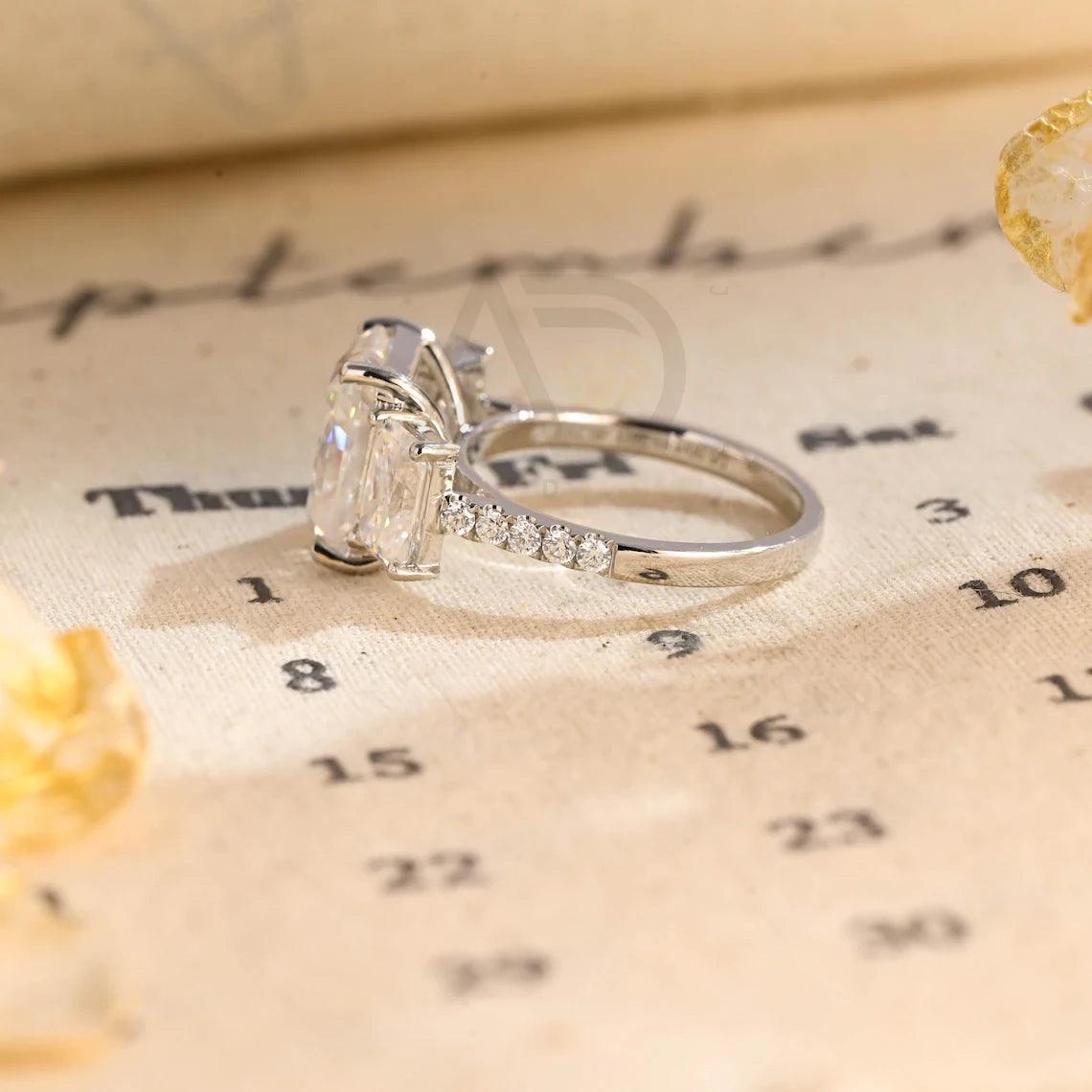 Delve into elegance and craftsmanship with our selection of Moissanite Engagement Rings, including radiant cut designs and Three Stone Wedding bands in Solid Gold. Celebrate your journey with a symbol as enduring as your love.