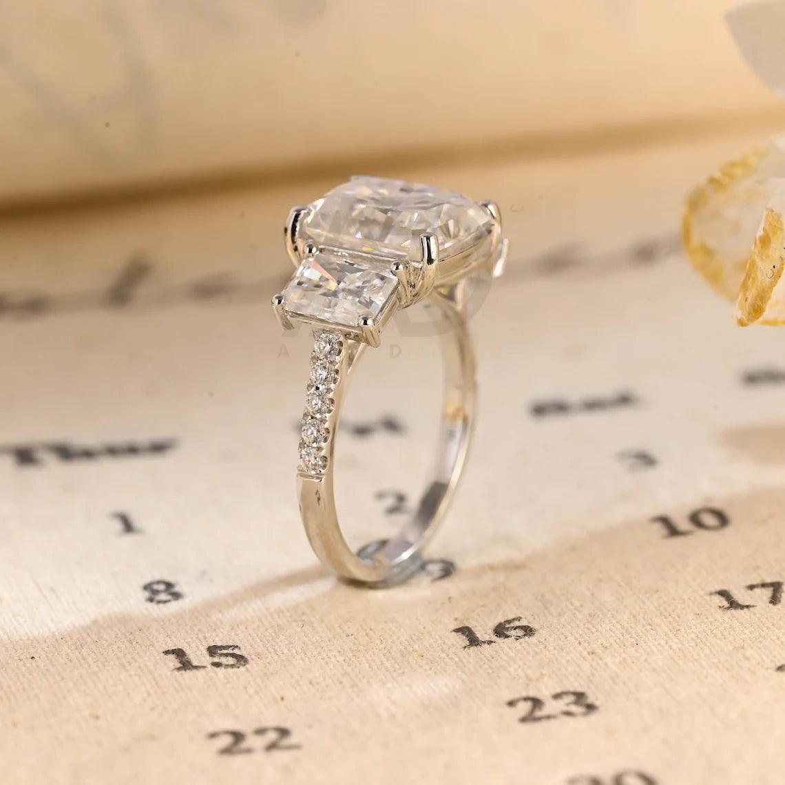 Delve into elegance and craftsmanship with our selection of Moissanite Engagement Rings, including radiant cut designs and Three Stone Wedding bands in Solid Gold. Celebrate your journey with a symbol as enduring as your love.