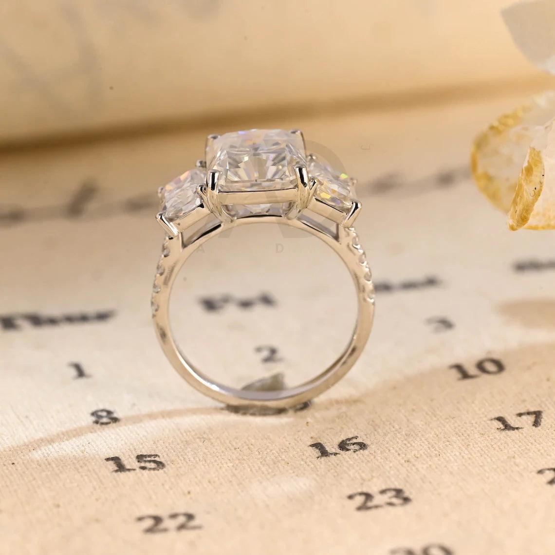 Delve into elegance and craftsmanship with our selection of Moissanite Engagement Rings, including radiant cut designs and Three Stone Wedding bands in Solid Gold. Celebrate your journey with a symbol as enduring as your love.