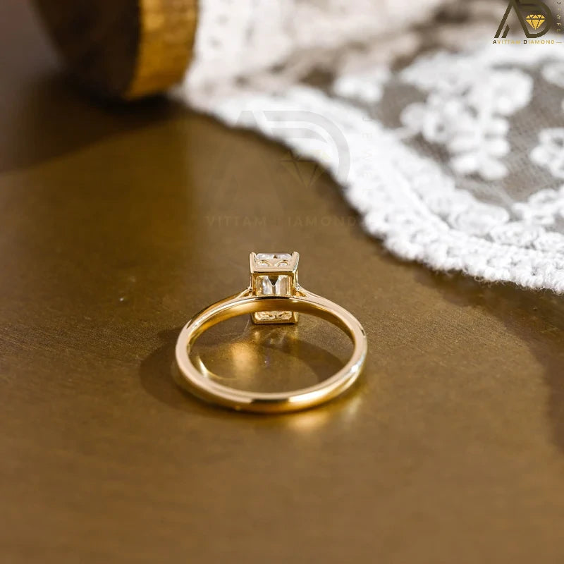 Discover our vintage style Emerald Cut Moissanite Solitaire Ring, designed to evoke timeless elegance. Perfect for engagements or as a unique gift for her.