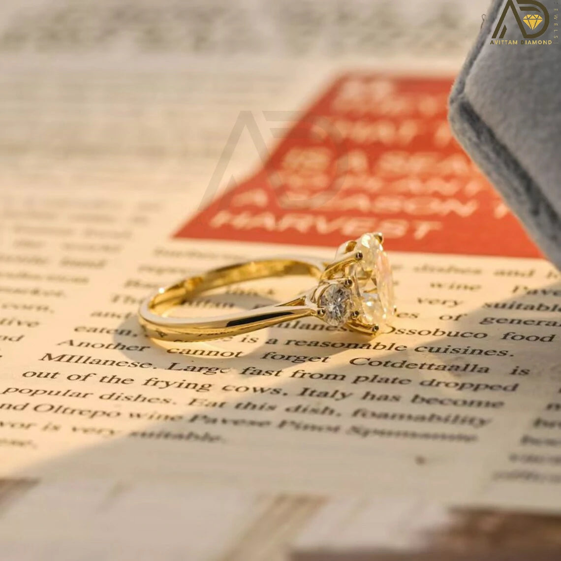 Discover our stunning Three Stone Moissanite Ring featuring an oval cut center and round side stones. Perfect for a unique engagement or wedding ring, this elegant piece showcases high-quality craftsmanship.