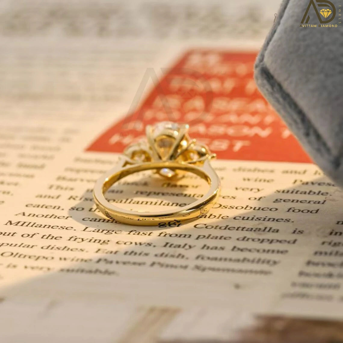 Discover our stunning Three Stone Moissanite Ring featuring an oval cut center and round side stones. Perfect for a unique engagement or wedding ring, this elegant piece showcases high-quality craftsmanship.