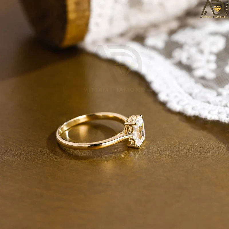 Discover our vintage style Emerald Cut Moissanite Solitaire Ring, designed to evoke timeless elegance. Perfect for engagements or as a unique gift for her.