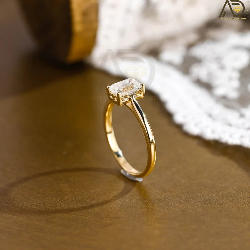 Discover our vintage style Emerald Cut Moissanite Solitaire Ring, designed to evoke timeless elegance. Perfect for engagements or as a unique gift for her.