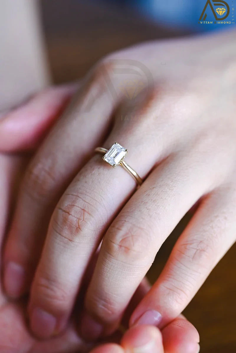 Discover our vintage style Emerald Cut Moissanite Solitaire Ring, designed to evoke timeless elegance. Perfect for engagements or as a unique gift for her.