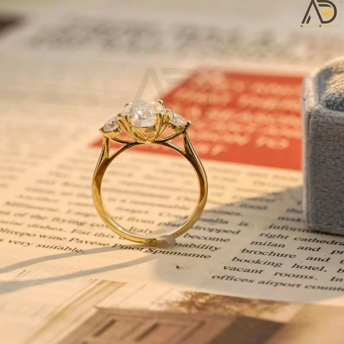 Discover our stunning Three Stone Moissanite Ring featuring an oval cut center and round side stones. Perfect for a unique engagement or wedding ring, this elegant piece showcases high-quality craftsmanship.