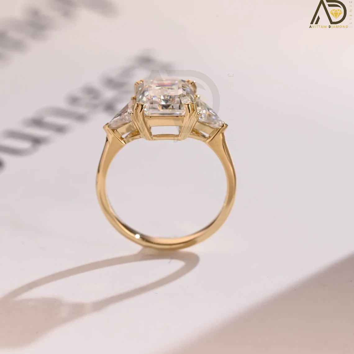 Solid Gold Emerald Cut Moissanite Engagement Ring with Trillion Side Stones. Perfect as a wedding ring, anniversary gift, or promise ring for her.