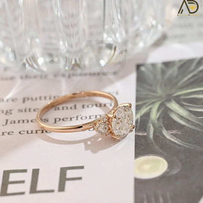 Discover our Three Stone Round Cut Moissanite Ring, a stunning choice for her engagement. Its elegant design and brilliance make it an unforgettable symbol of love.