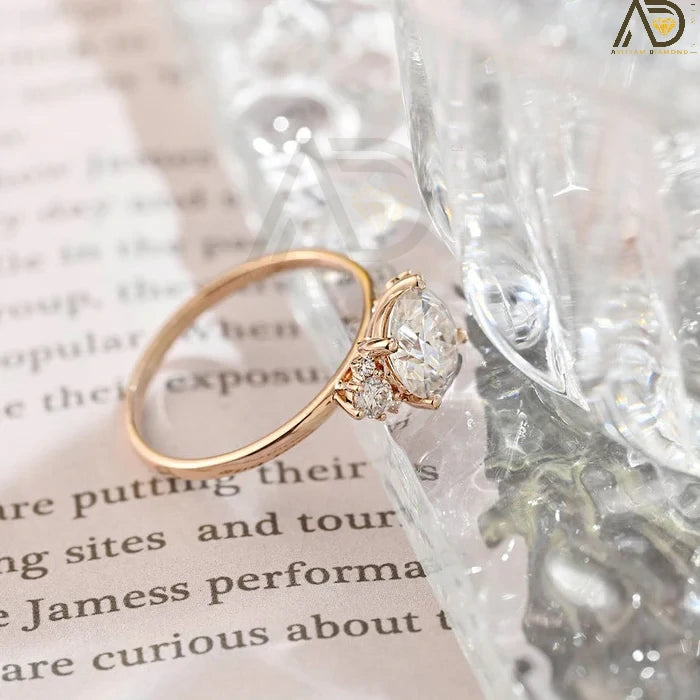 Discover our Three Stone Round Cut Moissanite Ring, a stunning choice for her engagement. Its elegant design and brilliance make it an unforgettable symbol of love.