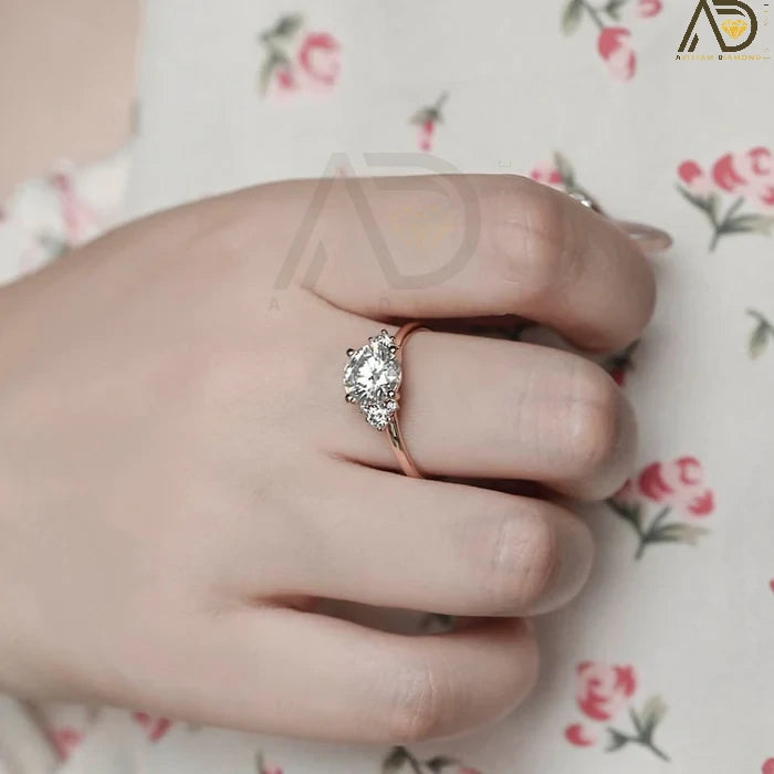 Discover our Three Stone Round Cut Moissanite Ring, a stunning choice for her engagement. Its elegant design and brilliance make it an unforgettable symbol of love.
