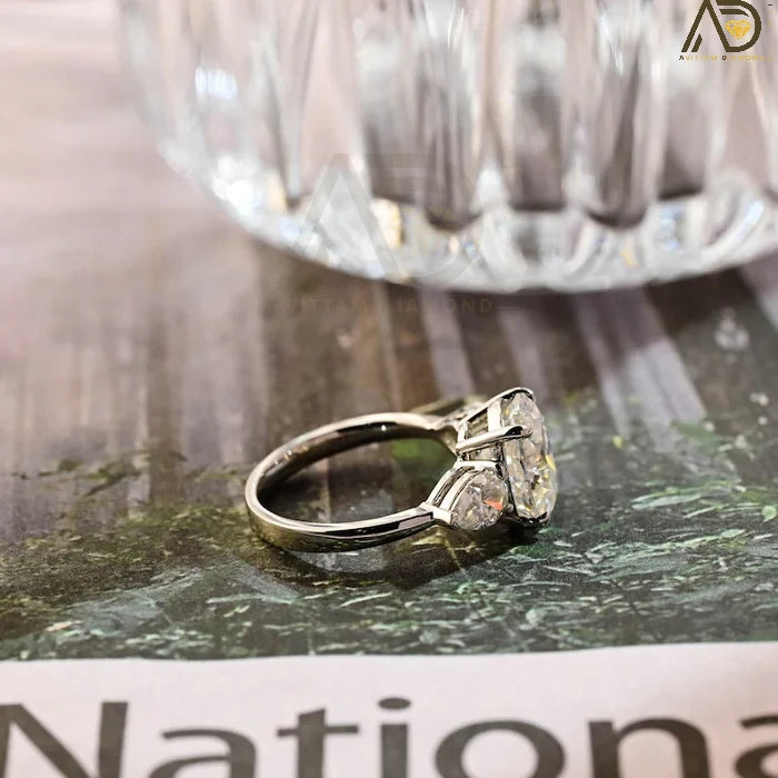 Discover our stunning Three Stone Moissanite Ring featuring an elegant oval cut center stone and pear cut side stones. A perfect choice for weddings or engagements!
