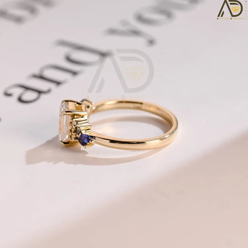 This Solid Gold Emerald Moissanite Engagement Ring features a stunning green marquise Moissanite accent, perfect as an anniversary or promise ring for her.