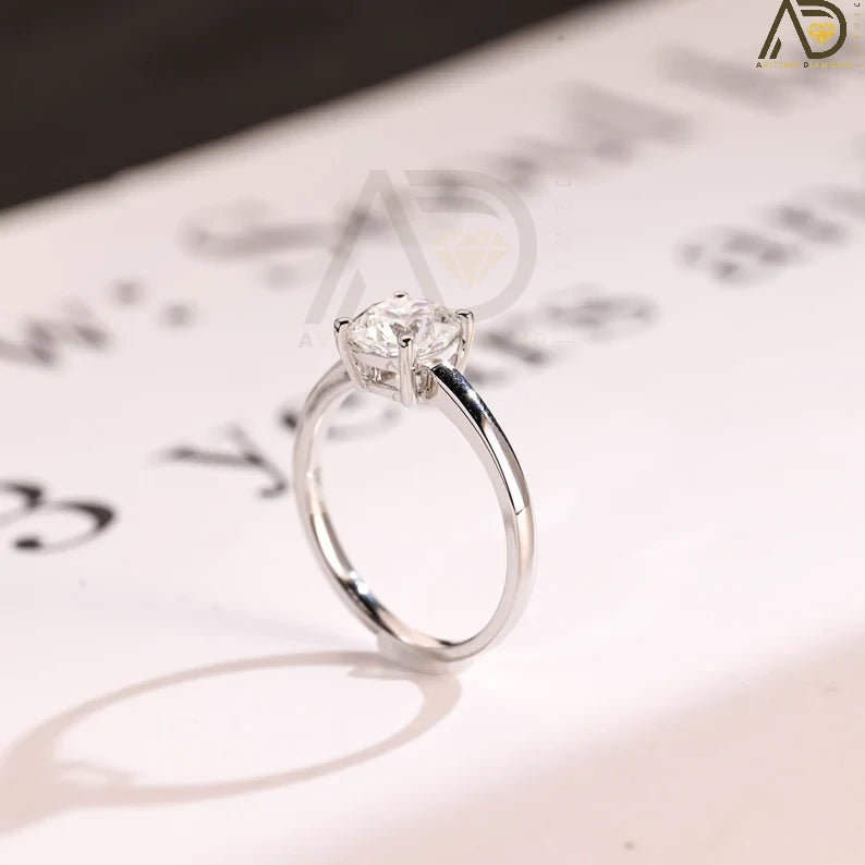Celebrate your love with our chic Solid Gold Cushion Cut Moissanite Engagement Ring. The bar setting adds a modern touch, making it an ideal anniversary gift, promise ring, or birthday surprise for her.